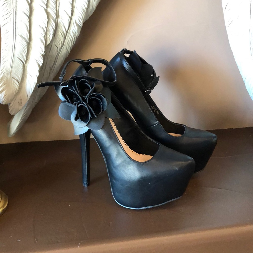 Black platform heels with flower detail